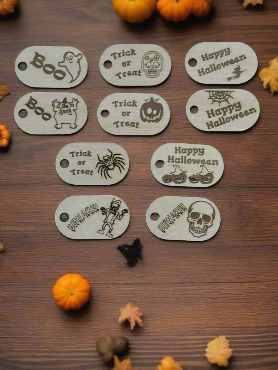 Set of Halloween-themed oval tags on a wooden surface