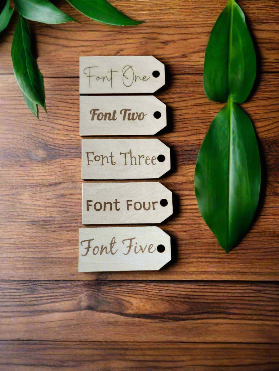 Five wooden tags with different font styles on a wooden surface