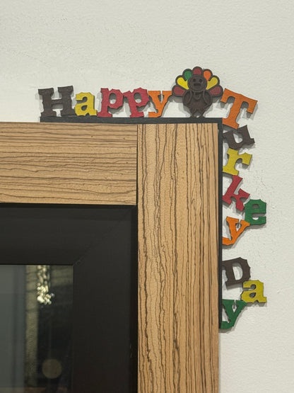Wooden frame with colorful 'Happy Turkey Day' letters on a white background