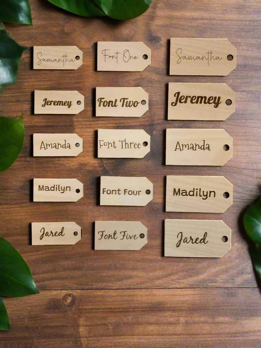 Set of wooden name tags with different fonts on a wooden background